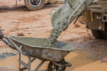 A cement truck is pouring cement