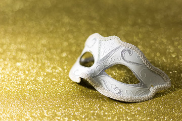 Female carnival mask on golden background