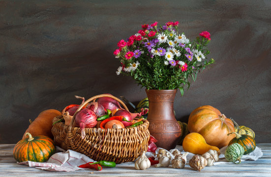 Still Life: vegetables and a bouquet of flowers. Autumn. Harvest.