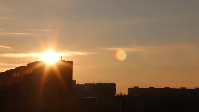 Sunset and silhouettes of residential buildings, time lapse