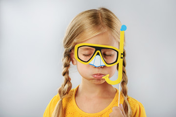 child with fake snorkel isolated on grey