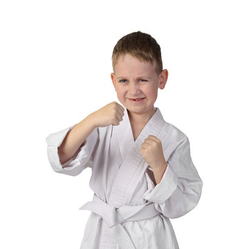 Karate boy stands in stance and going to punch isolated on white background in square