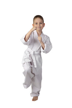 Karate boy stands in stance full height isolated on white background