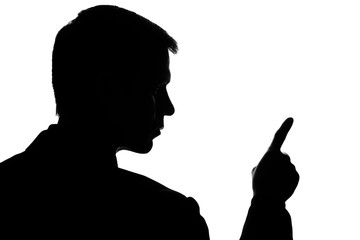 Young man in suit shows his index finger forward