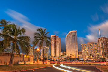 Luxurious hotels overlooking the Ala Wai Harbor at twilight and the light trails in Honolulu, Oahu,...
