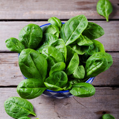 Baby spinach in Wooden background Top view
