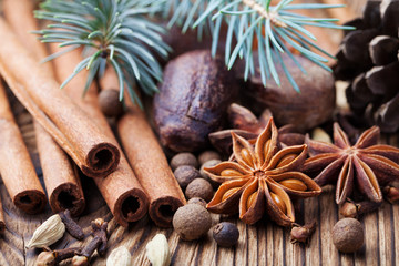 Christmas winter spices on wooden background. 