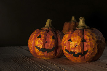 Halloween day pumpkins head jack o lantern on wooden ground in t