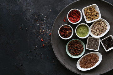 Super Food in bowls on dark ground