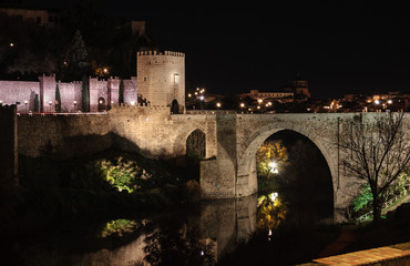 Puente romano sobre el rio Tajo (Puente de Alcántara) en Toledo de noche, España