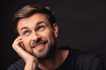 Dreamful guy expressing positive emotions