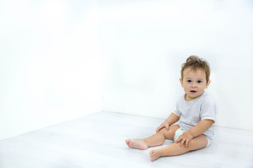 Naklejka premium Adorable baby boy sitting on the floor, close up, Asian, black eyes, hairstyle