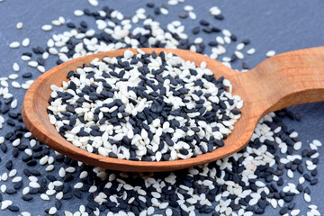 Black and white sesame in a wooden spoon