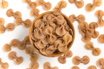 Wholegrain Farfalle into a bowl. wholemeal. Integral.