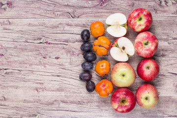 red apples and fruit on a rustic table