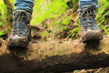 Detail of muddy boots in the way to the Lost three waterfalls hike in the highlands close to boquete, Panama.