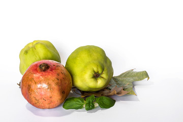 Fresh quinces and pomegranates isolated
