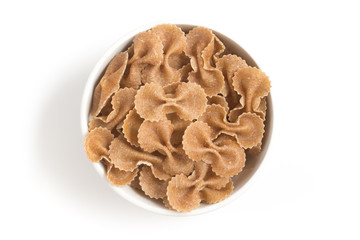 Wholegrain Farfalle into a bowl. wholemeal. Integral.
