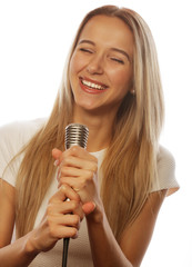 girl  with a microphone singing and having fun