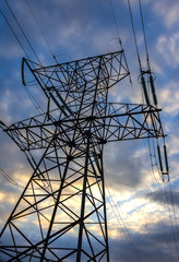High-voltage power line close-up on a background of clouds