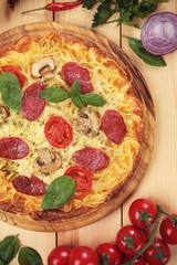 Spaghetti pizza with salami and mushrooms
