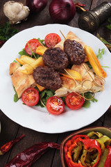 Kofta kebab with fried potatoes and flatbread