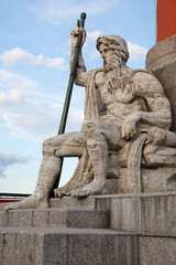 Fototapeta na wymiar Stone figure at the base of Rostral column on the Spit of Vasilyevsky Island in St. Petersburg