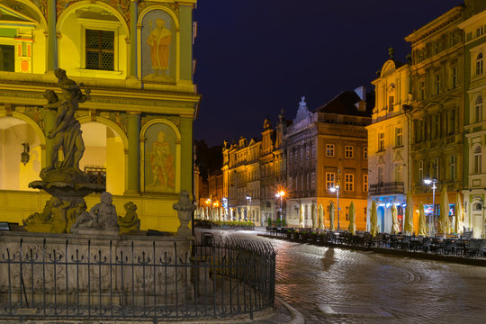  Night photo of Poznan Old Town with Prozerpin's fountain, beautifully decorated facade of the city hall and numerous highlighted townhouses.
