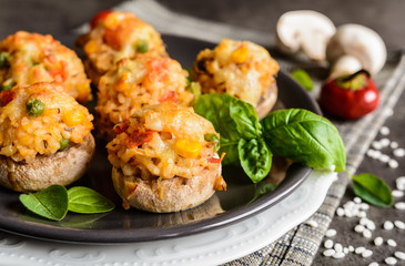 Mushrooms stuffed with rice, tomato, pea, corn and topped with mozzarella