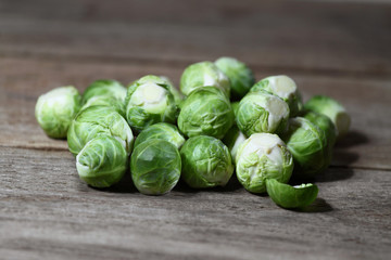 Pile of brussels sprouts on wooden table closeup