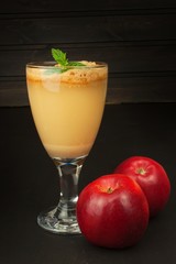 Fresh pressed apple juice unfiltered. Apple juice and apples on wooden table. A healthy juice for athletes. Autumn apple harvest.
