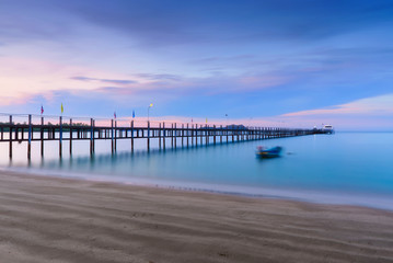 Low light long exposure scenery of a sea with woode bridge,with