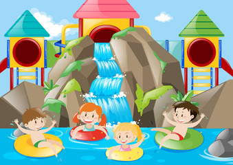 Kids swimming in the pool with waterfall