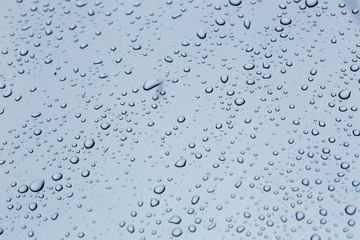 Rain drops on a car hood silver