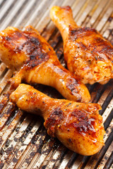 Hot grilled chicken legs on the grill