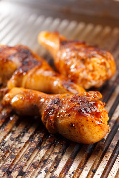 Hot grilled chicken legs on the grill