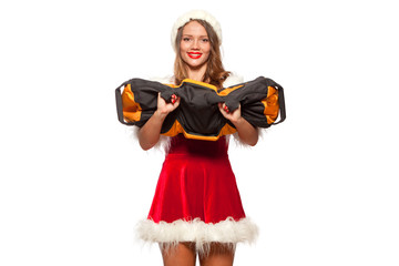 Fototapeta na wymiar christmas, x-mas, winter, happiness concept - Bodybuilding. Strong fit woman exercising with SANDBAG in santa helper hat , isolated on White Background. Muscular blonde girl lifting weights studio