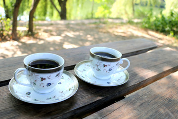On the table are filled with two cups of coffee on the nature,