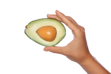 Female hand with fresh avocado fruit