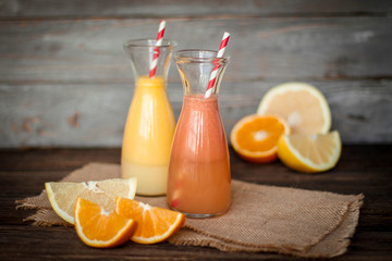 Naklejka na ściany i meble Fresh juice and smoothies with fruits on wooden background