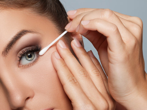 Woman with a cotton swab beside her eye