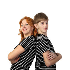 Redhead woman and teenage boy in similar t-shirts stand back to back and smile isolated on white background in square - mother and son, friendly family