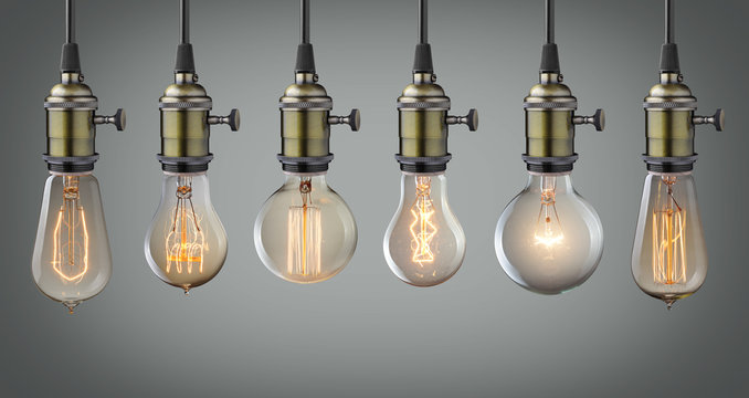 Vintage hanging light bulbs over gray background
