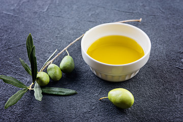 Olive branches and oil on a dark  background