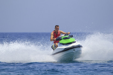 Tourists enjoy driving jetski on the ocean