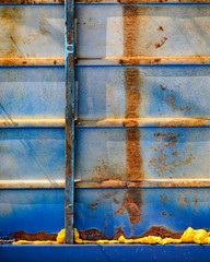 Multicolored background: rusty metal surface with blue paint flaking and cracking texture