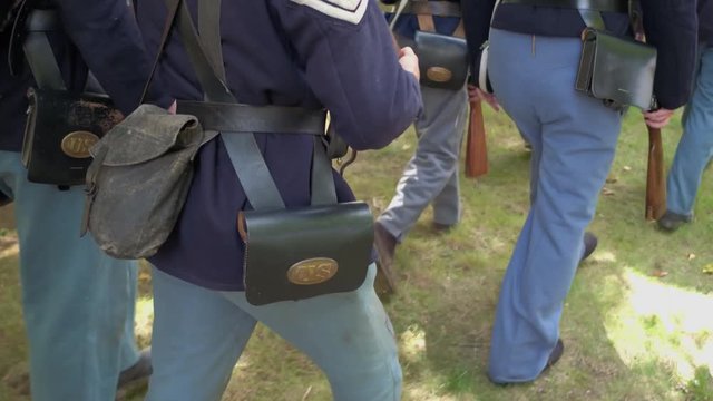 Civil War soldiers march with full gear