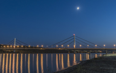 Night image of a road bridge over a wide river