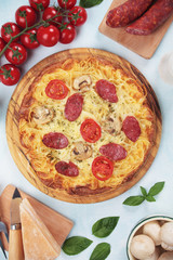 Spaghetti pizza with pepperoni and mushrooms