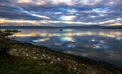 fishing boats under a cloud